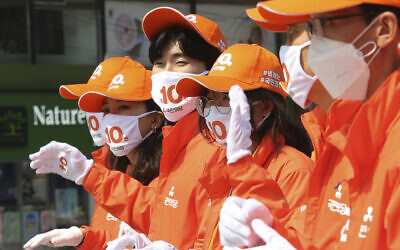 Supporters of the minor opposition People's Party wear face masks to help protect against the spread of the new coronavirus during a campaign for the 2020 South Korean National Assembly election in Seoul, South Korea, April 2, 2020. (AP Photo/Ahn Young-joon)