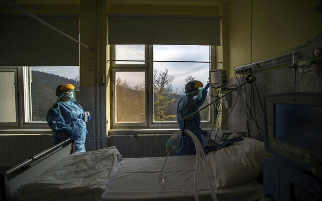 In this March 24, 2020, file photo, medical staff members check a ventilator in protective suits at the care unit for the new COVID-19 infected patients inside the Koranyi National Institute of Pulmonology in Budapest (Zoltan Balogh/MTI via AP, File) In this March 24, 2020, file photo, medical staff members check a ventilator in protective suits at the care unit for the new COVID-19 infected patients inside the Koranyi National Institute of Pulmonology in Budapest (Zoltan Balogh/MTI via AP, File)
