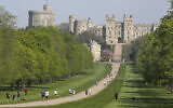 People exercise social distancing as they take their exorcise on the Long Walk in front of Windsor Castle during the Easter bank holiday weekend, as the UK continues in lockdown to help curb the spread of the coronavirus, in Windsor, England, April 10, 2020.  (Steve Parsons / PA via AP)