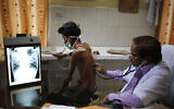 In this March 24, 2014, file photo, a doctor examines a tuberculosis patient in a government TB hospital in Allahabad, India. (AP Photo/Rajesh Kumar Singh, File)