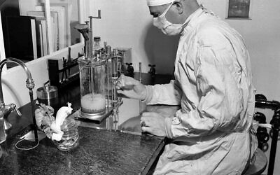 In this December 2, 1947, photo, Charles D. Brown fills a vial with the BCG tuberculosis vaccine, at a state-operated laboratory in Albany, NY (AP Photo)