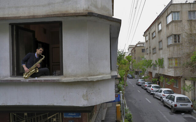 In this April 8, 2020 photo, Mohammad Maleklee, 23, of the National Orchestra of Iran and Tehran Symphony, plays saxophone at his window during mandatory self-isolation due to the new coronavirus disease outbreak, in Tehran, Iran. (AP Photo/Ebrahim Noroozi) In this April 8, 2020 photo, Mohammad Maleklee, 23, of the National Orchestra of Iran and Tehran Symphony, plays saxophone at his window during mandatory self-isolation due to the new coronavirus disease outbreak, in Tehran, Iran. (AP Photo/Ebrahim Noroozi)