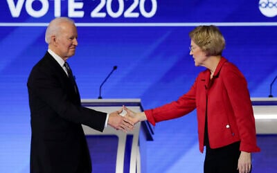 Democratic presidential candidates former Vice President Joe Biden, left, and Sen. Elizabeth Warren, Democrat-Massachusetts, shake hands on stage before the start of a Democratic presidential primary debate hosted by ABC News, Apple News, and WMUR-TV at Saint Anselm College in Manchester, New Hampshire, February 7, 2020. (Charles Krupa/AP)