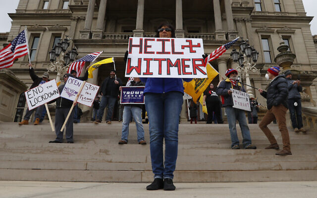 Dawn Perreca protests on the front steps of the Michigan State Capitol building in Lansing, Michigan, April 15, 2020 (AP Photo/Paul Sancya) Dawn Perreca protests on the front steps of the Michigan State Capitol building in Lansing, Michigan, April 15, 2020 (AP Photo/Paul Sancya)