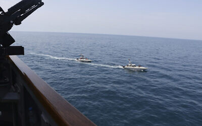 Illustrative: Iranian Revolutionary Guard vessels sail close to US military ships in the Persian Gulf near Kuwait, April 15, 2020. (US Navy via AP)