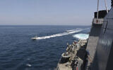Iranian Revolutionary Guard vessels sail close to US military ships in the Persian Gulf near Kuwait, April 15, 2020. (US Navy via AP)