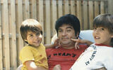 This circa 1987 photo provided by the family shows Isaiah Kuperstein with his sons, Daniel, left, and Adam in the Queens borough of New York. (Kuperstein family via AP)