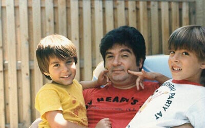 This circa 1987 photo provided by the family shows Isaiah Kuperstein with his sons, Daniel, left, and Adam in the Queens borough of New York. (Kuperstein family via AP)