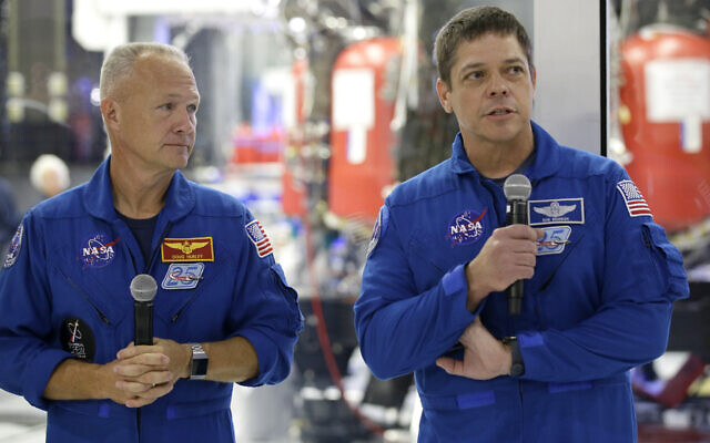 In this October 10, 2019, photo, NASA astronauts Bob Behnken, right, and Doug Hurley talk to the media in front of the Crew Dragon spacecraft at SpaceX headquarters in Hawthorne, California. (AP Photo/Alex Gallardo) In this October 10, 2019, photo, NASA astronauts Bob Behnken, right, and Doug Hurley talk to the media in front of the Crew Dragon spacecraft at SpaceX headquarters in Hawthorne, California. (AP Photo/Alex Gallardo)