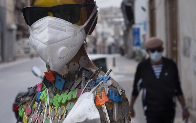 In this April 5, 2020 photo, a face mask for sale is displayed on a mannequin amid concerns over the country's coronavirus outbreak in Tel Aviv, Israel. (AP Photo/Oded Balilty)