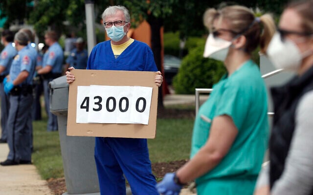 Counter-protesters stand as people with ReopenNC demonstrate in Raleigh, N.C., to press Gov. Roy Cooper to allow businesses to reopen during the COVID-19 outbreak Tuesday, April 21, 2020. (AP Photo/Gerry Broome) Counter-protesters stand as people with ReopenNC demonstrate in Raleigh, N.C., to press Gov. Roy Cooper to allow businesses to reopen during the COVID-19 outbreak Tuesday, April 21, 2020. (AP Photo/Gerry Broome)