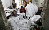 In this Monday, March 30, 2020 file photo, Palestinians make protective overalls meant to shield people from the coronavirus, to be exported to Israel, at a local factory in Gaza City (AP Photo/Adel Hana, File)