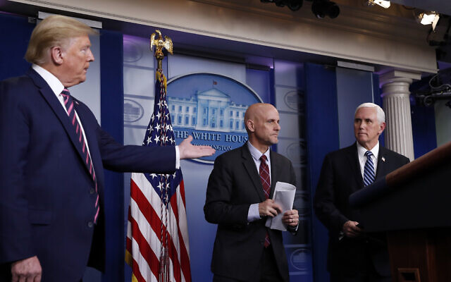 President Donald Trump gestures to Vice President Mike Pence as Stephen Hahn, commissioner of the US Food and Drug Administration, steps back to the podium to answer a question during a briefing about the coronavirus in the James Brady Press Briefing Room of the White House, Friday, April 24, 2020, in Washington. (AP Photo/Alex Brandon) President Donald Trump gestures to Vice President Mike Pence as Stephen Hahn, commissioner of the US Food and Drug Administration, steps back to the podium to answer a question during a briefing about the coronavirus in the James Brady Press Briefing Room of the White House, Friday, April 24, 2020, in Washington. (AP Photo/Alex Brandon)