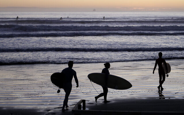 Surfers prepare to enter the water at Sumner Beach as COVID-19 restrictions are eased in Christchurch, New Zealand, April 28, 2020. (AP Photo/Mark Baker) Surfers prepare to enter the water at Sumner Beach as COVID-19 restrictions are eased in Christchurch, New Zealand, April 28, 2020. (AP Photo/Mark Baker)