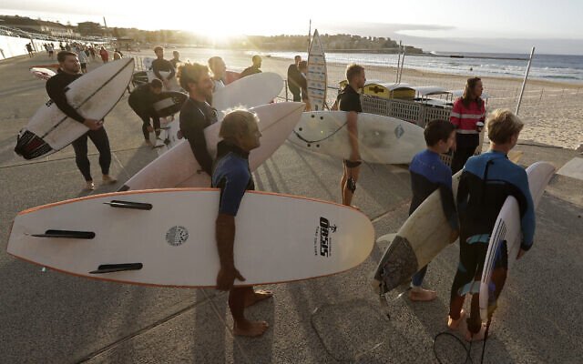 Surfers wait for officials to open Bondi Beach in Sydney, Tuesday, April 28, 2020, as coronavirus pandemic restrictions are eased. The beach is open to swimmers and surfers to exercise only. (AP Photo/Rick Rycroft) Surfers wait for officials to open Bondi Beach in Sydney, Tuesday, April 28, 2020, as coronavirus pandemic restrictions are eased. The beach is open to swimmers and surfers to exercise only. (AP Photo/Rick Rycroft)
