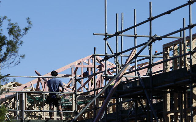 Builders work on a construction site as level four COVID-19 restrictions are eased in Christchurch, New Zealand, Tuesday, April 28, 2020. New Zealand eased its strict lockdown restrictions to level three at midnight to open up certain sections of the economy but social distancing rules will still apply. (AP Photo/Mark Baker) Builders work on a construction site as level four COVID-19 restrictions are eased in Christchurch, New Zealand, Tuesday, April 28, 2020. New Zealand eased its strict lockdown restrictions to level three at midnight to open up certain sections of the economy but social distancing rules will still apply. (AP Photo/Mark Baker)