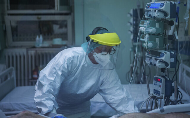 A nurse at the intensive care unit for COVID-19 patients during a night shift at Szent Laszlo Hospital in Budapest, Hungary, April 27, 2020. (Balogh Zoltán/MTI via AP) A nurse at the intensive care unit for COVID-19 patients during a night shift at Szent Laszlo Hospital in Budapest, Hungary, April 27, 2020. (Balogh Zoltán/MTI via AP)