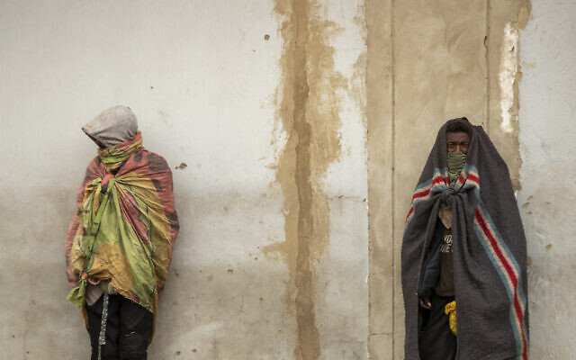 Homeless men stand against the wall on the street of downtown Johannesburg, South Africa, Tuesday, April 28, 2020. Many have lost their income as South Africa is under a strict five-week lockdown in a effort to fight the coronavirus pandemic. (AP Photo/Themba Hadebe) Homeless men stand against the wall on the street of downtown Johannesburg, South Africa, Tuesday, April 28, 2020. Many have lost their income as South Africa is under a strict five-week lockdown in a effort to fight the coronavirus pandemic. (AP Photo/Themba Hadebe)