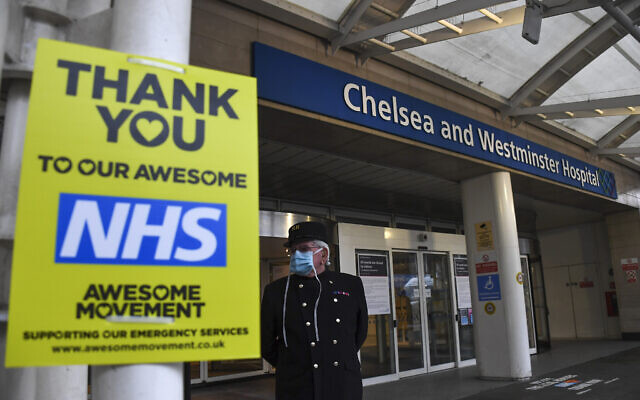 A Chelsea pensioner stands outside the Chelsea and Westminster Hospital, in London, wearing a protective mask due to the coronavirus outbreak, as people across the country pay tribute to health care workers who have died from the coronavirus, Tuesday, April 28, 2020. A national one minute silence was observed to pay tribute to essential workers who have died from the COVID-19 coronavirus. (AP Photo/Alberto Pezzali) A Chelsea pensioner stands outside the Chelsea and Westminster Hospital, in London, wearing a protective mask due to the coronavirus outbreak, as people across the country pay tribute to health care workers who have died from the coronavirus, Tuesday, April 28, 2020. A national one minute silence was observed to pay tribute to essential workers who have died from the COVID-19 coronavirus. (AP Photo/Alberto Pezzali)