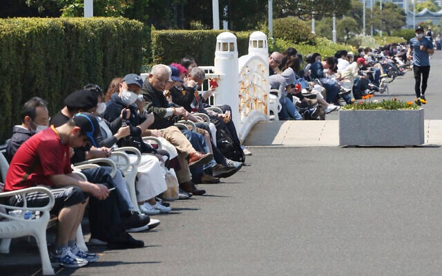 People sit on the bench at a park in Yokohama, near Tokyo, on a national holiday, April 29, 2020. (AP Photo/Koji Sasahara) People sit on the bench at a park in Yokohama, near Tokyo, on a national holiday, April 29, 2020. (AP Photo/Koji Sasahara)