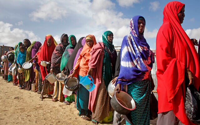 In this Saturday, May 18, 2019 file photo, newly-arrived women who fled drought line up to receive food distributed by local volunteers at a camp for displaced persons in the Daynile neighborhood on the outskirts of the Somalian capital Mogadishu. (AP Photo/Farah Abdi Warsameh) In this Saturday, May 18, 2019 file photo, newly-arrived women who fled drought line up to receive food distributed by local volunteers at a camp for displaced persons in the Daynile neighborhood on the outskirts of the Somalian capital Mogadishu. (AP Photo/Farah Abdi Warsameh)