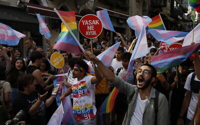 People celebrate on the street during a Pride march event banned by authorities, in Istanbul on June 30, 2019. (AP Photo/Lefteris Pitarakis)