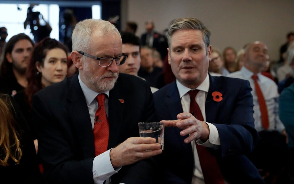 File: Britain's opposition Labour party leader Jeremy Corbyn, left, passes a glass of water to Keir Starmer Labour's Shadow Secretary of State for Exiting the European Union as they wait to speak during their election campaign event on Brexit in Harlow, England, Tuesday, Nov. 5, 2019 (AP Photo/Matt Dunham) File: Britain's opposition Labour party leader Jeremy Corbyn, left, passes a glass of water to Keir Starmer Labour's Shadow Secretary of State for Exiting the European Union as they wait to speak during their election campaign event on Brexit in Harlow, England, Tuesday, Nov. 5, 2019 (AP Photo/Matt Dunham)