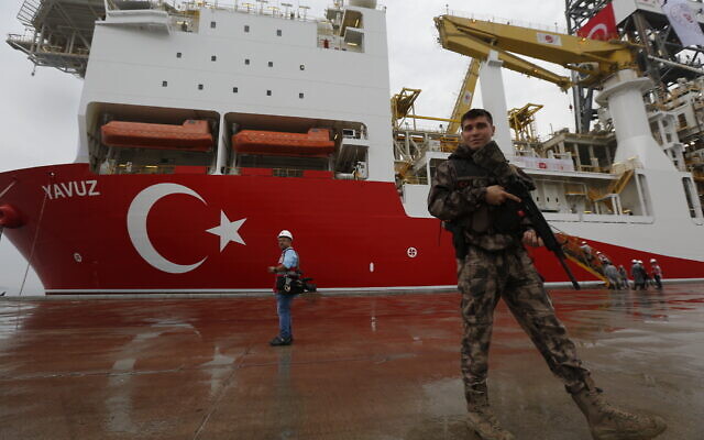 Illustrative: In this June 20, 2019, photo, a Turkish police officer patrols the dock, backdropped by the drilling ship Yavuz which has since been dispatched to the Mediterranean, at the port of Dilovasi, outside Istanbul. (AP Photo/Lefteris Pitarakis) Illustrative: In this June 20, 2019, photo, a Turkish police officer patrols the dock, backdropped by the drilling ship Yavuz which has since been dispatched to the Mediterranean, at the port of Dilovasi, outside Istanbul. (AP Photo/Lefteris Pitarakis)