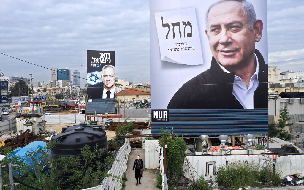 Election campaign billboards for Likud and its leader Prime Minister Benjamin Netanyahu (foreground), and the Blue and White party led by Benny Gantz (background), in Bnei Brak, February 23, 2020. (AP Photo/Oded Balilty) Election campaign billboards for Likud and its leader Prime Minister Benjamin Netanyahu (foreground), and the Blue and White party led by Benny Gantz (background), in Bnei Brak, February 23, 2020. (AP Photo/Oded Balilty)