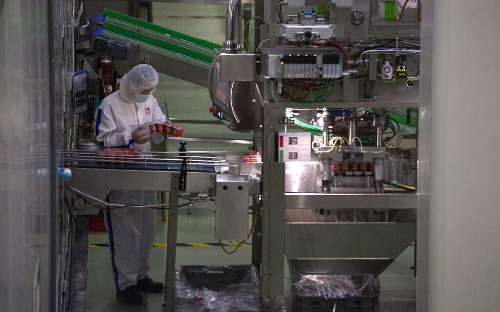 Illustrative: In this Thursday, February 27, 2020, photo, a worker checks yogurt coming off the production line at the Mengniu dairy factory in Beijing. Reporters were invited to China Mengniu Dairy Co. Ltd. this week to be shown how companies are reviving after anti-virus measures shut down most of the world's second-biggest economy. (AP Photo/Ng Han Guan) Illustrative: In this Thursday, February 27, 2020, photo, a worker checks yogurt coming off the production line at the Mengniu dairy factory in Beijing. Reporters were invited to China Mengniu Dairy Co. Ltd. this week to be shown how companies are reviving after anti-virus measures shut down most of the world's second-biggest economy. (AP Photo/Ng Han Guan)
