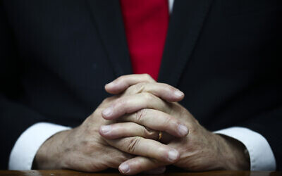 Prime Minister Benjamin Netanyahu's hands clasped as he chairs the weekly cabinet meeting in Jerusalem, March. 8, 2020. (AP Photo/Oded Balilty, Pool)
