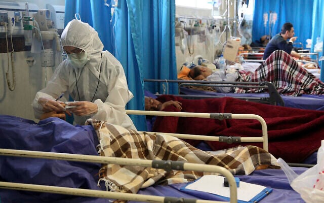 A medic treats a patient infected with the new coronavirus, at a hospital in Tehran, Iran, March 8, 2020. (AP Photo/Mohammad Ghadamali) A medic treats a patient infected with the new coronavirus, at a hospital in Tehran, Iran, March 8, 2020. (AP Photo/Mohammad Ghadamali)