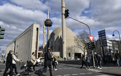 People near the German central DITIB mosque in Cologne, Germany, March 15, 2020, after the city banned religious services due to the coronavirus outbreak.  (AP Photo/Martin Meissner)