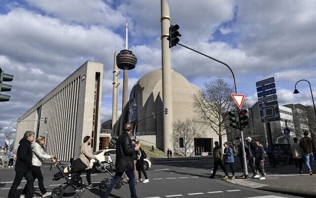 People near the German central DITIB mosque in Cologne, Germany, March 15, 2020, after the city banned religious services due to the coronavirus outbreak. (AP Photo/Martin Meissner) People near the German central DITIB mosque in Cologne, Germany, March 15, 2020, after the city banned religious services due to the coronavirus outbreak. (AP Photo/Martin Meissner)