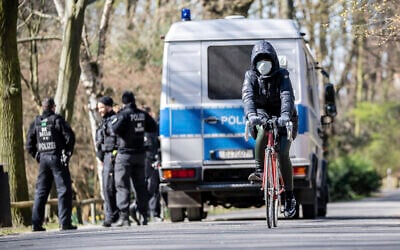 [Illustrative] German police patrol to make sure that the distance regulations are observed during the coronavirus outbreak in Berlin, Germany, Monday, March 23, 2020. (Michael Kappeler/dpa via AP)
