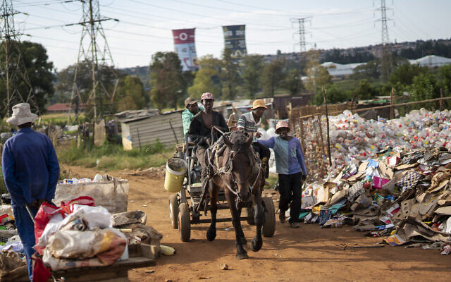 Men who collect trash to recycle bring it to a sales point in an informal settlement of Soweto, South Africa, March 25, 2020. (AP Photo/Jerome Delay) Men who collect trash to recycle bring it to a sales point in an informal settlement of Soweto, South Africa, March 25, 2020. (AP Photo/Jerome Delay)
