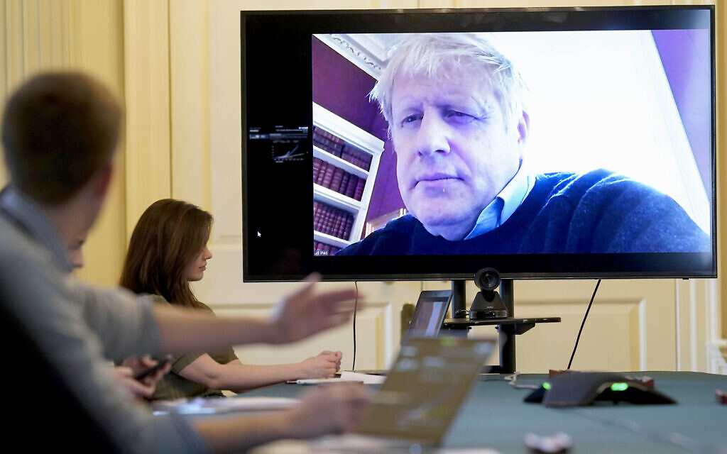 In this handout photo provided by Number 10 Downing Street, Britain's Prime Minister Boris Johnson chairs the morning Covid-19 Meeting remotely after self isolating after testing positive for the coronavirus, at 10 Downing Street, London, March 28, 2020. (Andrew Parsons/10 Downing Street via AP) In this handout photo provided by Number 10 Downing Street, Britain's Prime Minister Boris Johnson chairs the morning Covid-19 Meeting remotely after self isolating after testing positive for the coronavirus, at 10 Downing Street, London, March 28, 2020. (Andrew Parsons/10 Downing Street via AP)