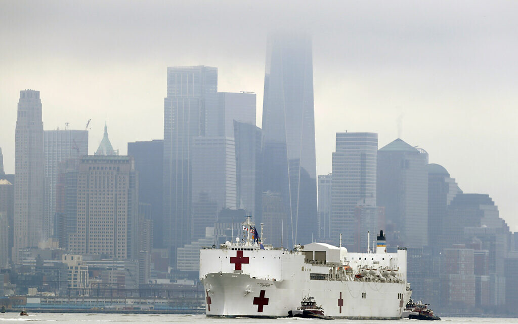 The Navy hospital ship USNS Comfort passes lower Manhattan on its way to docking in New York, Monday, March 30, 2020. The ship has 1,000 beds and 12 operating rooms. (AP Photo/Seth Wenig)