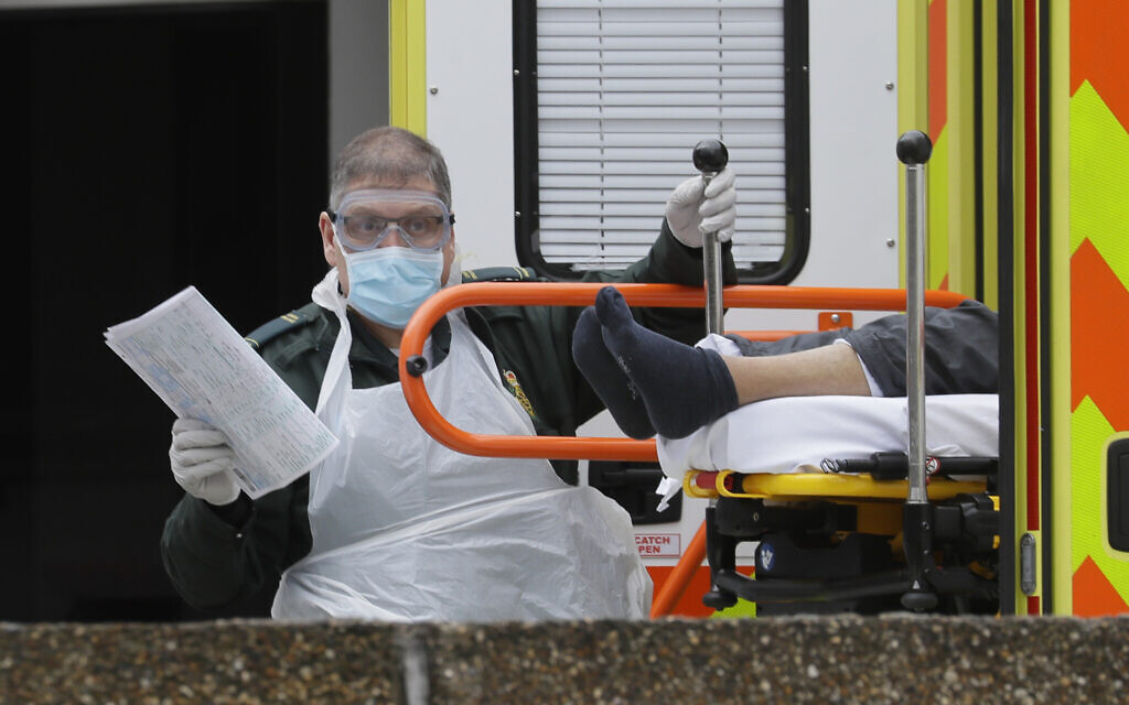 A patients is helped from an ambulance as they arrive at St Thomas' Hospital, one of may hospitals that are in the front line of the coronavirus outbreak, in London, March 31, 2020. (AP Photo/Kirsty Wigglesworth) A patients is helped from an ambulance as they arrive at St Thomas' Hospital, one of may hospitals that are in the front line of the coronavirus outbreak, in London, March 31, 2020. (AP Photo/Kirsty Wigglesworth)
