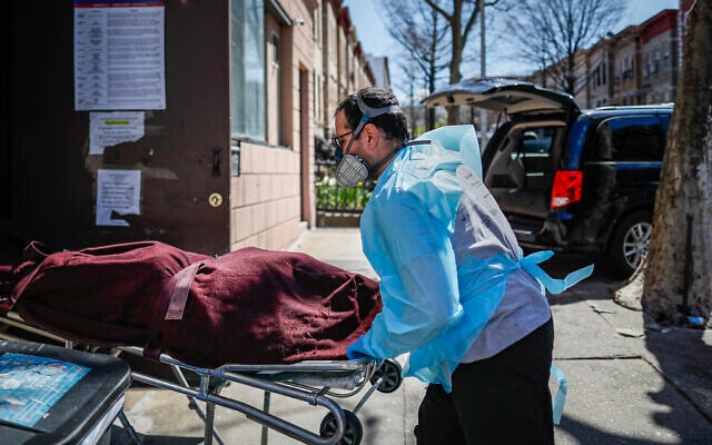 Employees deliver a body at Daniel J. Schaefer Funeral Home, Thursday, April 2, 2020, in the Brooklyn borough of New York. (AP/John Minchillo) Employees deliver a body at Daniel J. Schaefer Funeral Home, Thursday, April 2, 2020, in the Brooklyn borough of New York. (AP/John Minchillo)