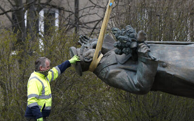 The statue of Soviet World War II commander Marshall Ivan Stepanovic Konev is loaded onto a truck after its removal from its site in Prague, Czech Republic on April 3, 2020. (AP Photo/Petr David Josek)
