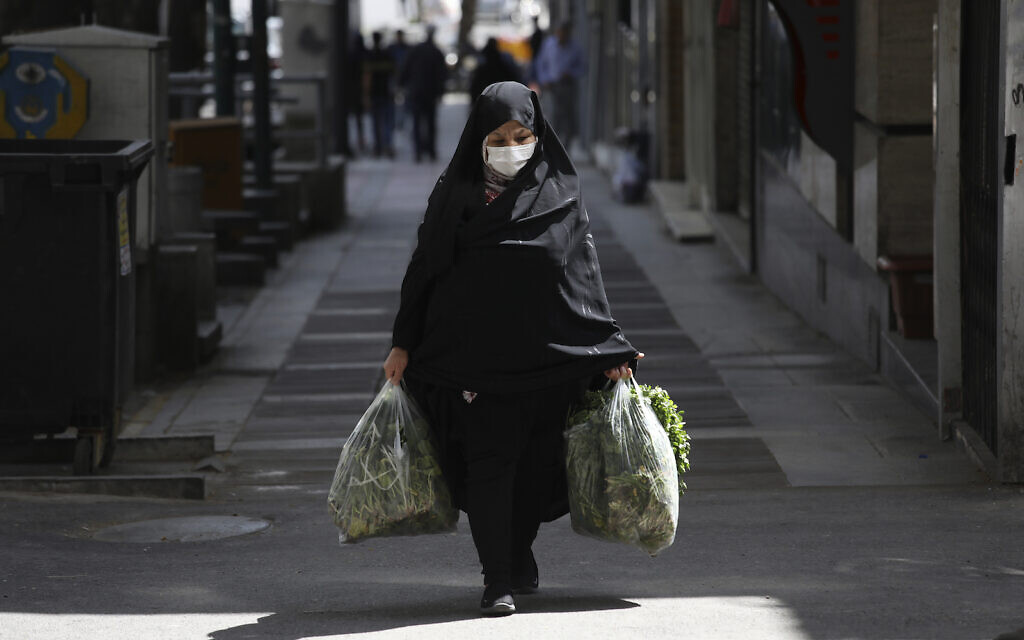 A woman wearing a face mask to protect against the new coronavirus carries her shopping in northern Tehran, Iran, Saturday, April 4, 2020. (AP Photo/Vahid Salemi) A woman wearing a face mask to protect against the new coronavirus carries her shopping in northern Tehran, Iran, Saturday, April 4, 2020. (AP Photo/Vahid Salemi)