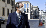 The governor of Region Lombardy, the coronavirus worst-hit region of Italy, Attilio Fontana wears a face mask as he walks in Milan, Italy, April 5, 2020. (Claudio Furlan/LaPresse via AP)