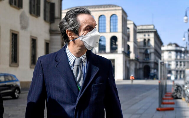 The governor of Region Lombardy, the coronavirus worst-hit region of Italy, Attilio Fontana wears a face mask as he walks in Milan, Italy, April 5, 2020. (Claudio Furlan/LaPresse via AP) The governor of Region Lombardy, the coronavirus worst-hit region of Italy, Attilio Fontana wears a face mask as he walks in Milan, Italy, April 5, 2020. (Claudio Furlan/LaPresse via AP)