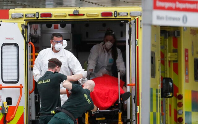 Medical workers wearing equipment to protect themselves from coronavirus bring a patient to St Thomas' Hospital in Westminster in London, April 6, 2020 (AP Photo/Frank Augstein) Medical workers wearing equipment to protect themselves from coronavirus bring a patient to St Thomas' Hospital in Westminster in London, April 6, 2020 (AP Photo/Frank Augstein)
