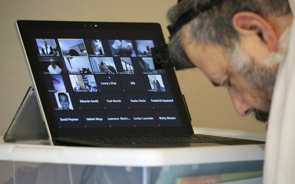Illustrative: A rabbi leads a virtual morning minyan from his home, April 6, 2020. (AP/Jacquelyn Martin) Illustrative: A rabbi leads a virtual morning minyan from his home, April 6, 2020. (AP/Jacquelyn Martin)