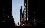 A person wearing a protective face mask for protect against COVID-19 walks in New York, Monday, April 6, 2020, during the coronavirus outbreak. (AP/Matt Rourke)