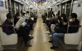 Commuters ride a train in Tokyo, April 7, 2020. (Jae C. Hong/AP)