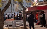 Ultra-Orthodox Jews some wearing face masks line up to buy eggs, in Bnei Brak, Israel, Wednesday, April 8, 2020. (AP/Oded Balilty)