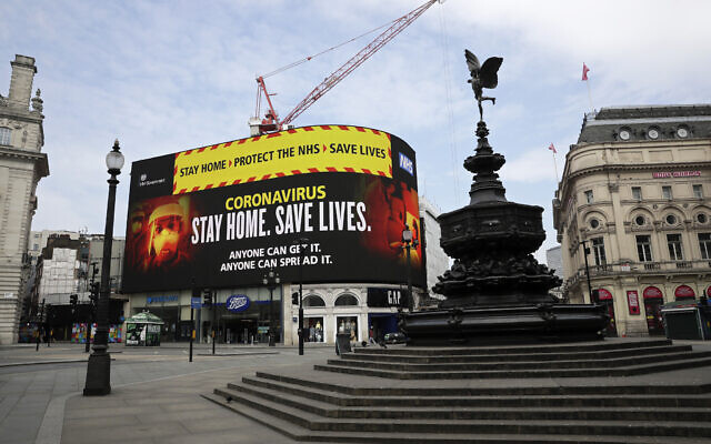 A video screen displays a message urging people to stay home in a nearly deserted Piccadilly Circus in London, Wednesday, April 8, 2020. (AP Photo/Matt Dunham) A video screen displays a message urging people to stay home in a nearly deserted Piccadilly Circus in London, Wednesday, April 8, 2020. (AP Photo/Matt Dunham)